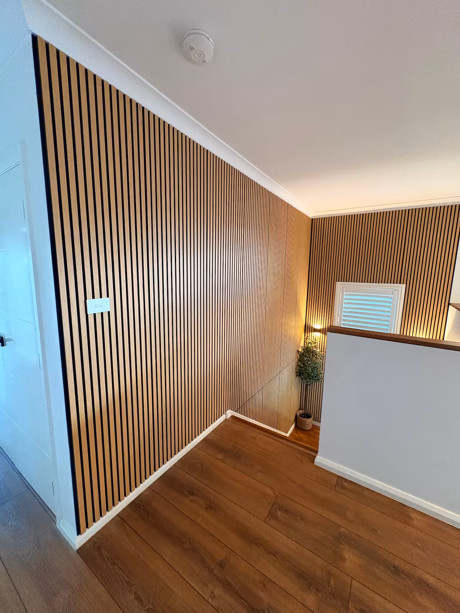Interior timber slat feature wall and staircase carpentry by Formex Constructions