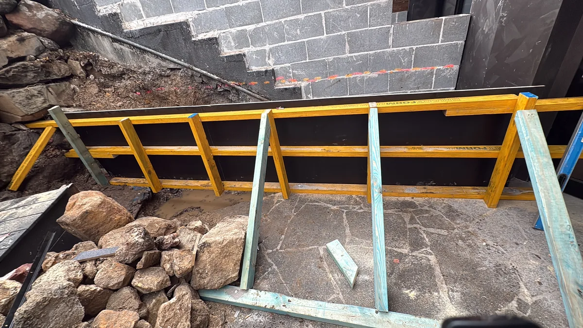 Concreting & Excavations project — Formwork against a besser block retaining wall