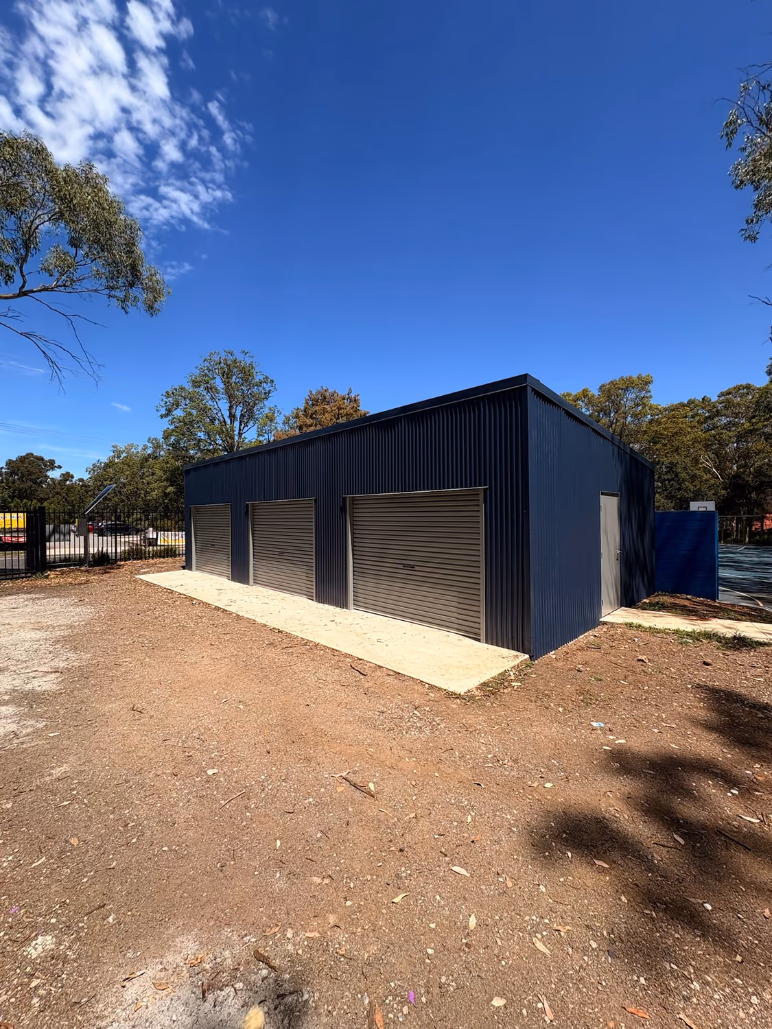 Charcoal Colorbond workshop shed with roller doors built by Formex Constructions