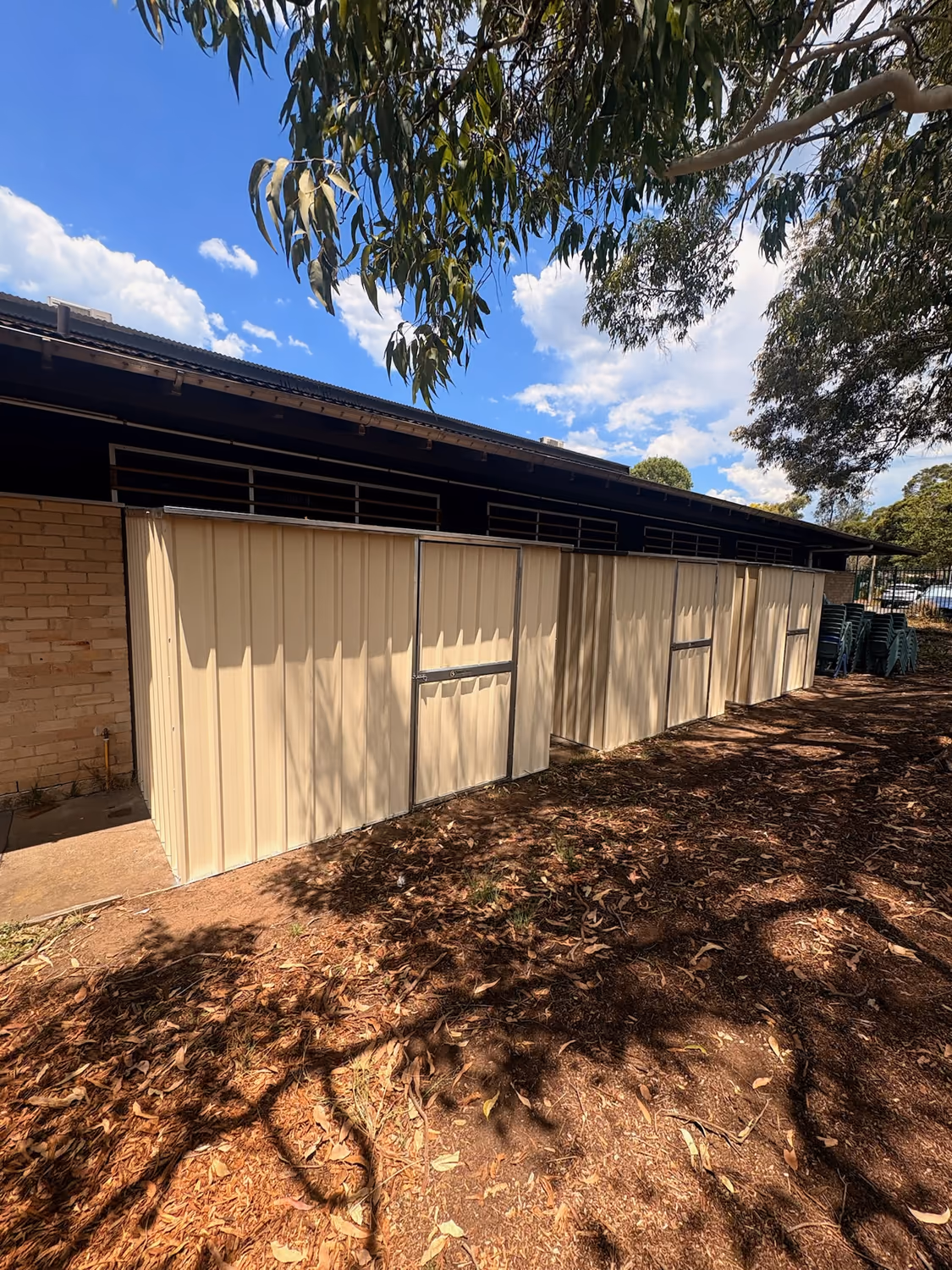 Row of cream Colorbond sheds installed by Formex Constructions in Western Sydney