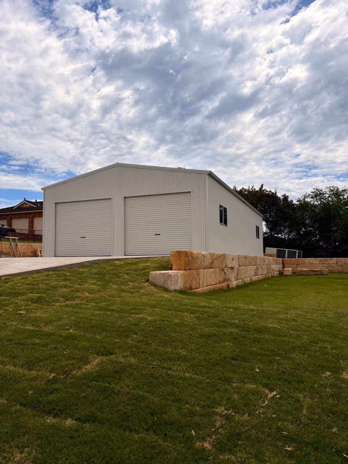 Double-door Colorbond workshop shed with roller doors built by Formex Constructions