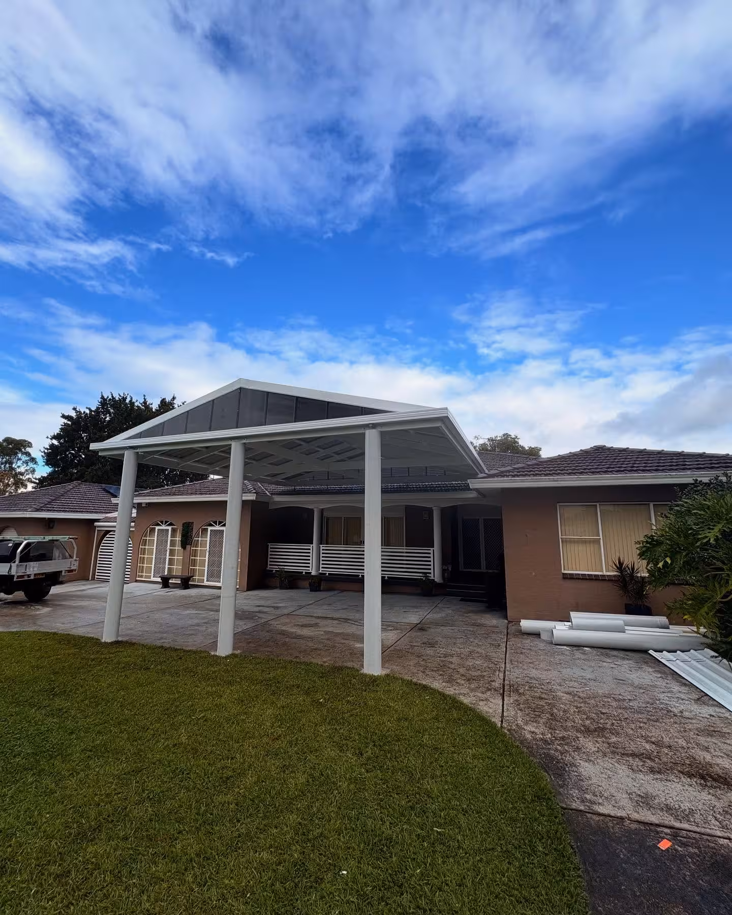 White gable-roof carport and patio structure built by Formex Constructions