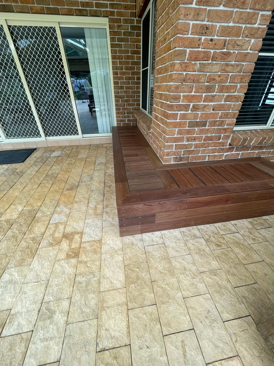 Detail of a multi-level hardwood deck step and threshold transition